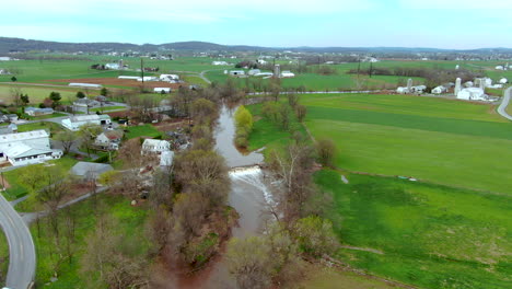 aerial view of rapids on a small river in the american countryside, farms and country houses on the banks, conestoga river in lancaster county, pennsylvania