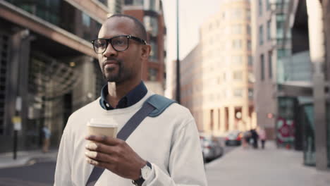 african american businessman walking through city