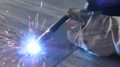 welder on the table welds a set of metal parts