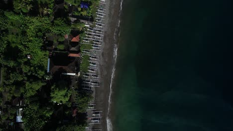 birds eye view of boats along the shoreline on the beautiful beach in amed, bali