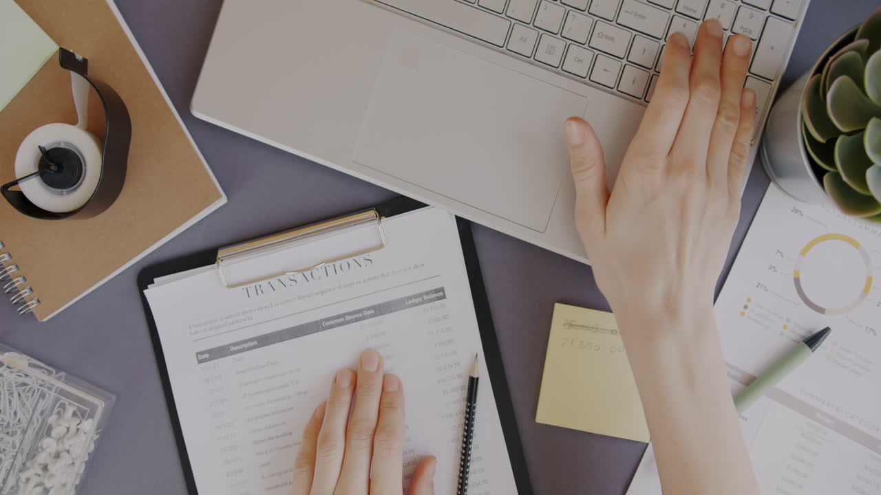 Woman working on financial documents and spreadsheets