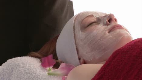 a woman receiving a facial massage