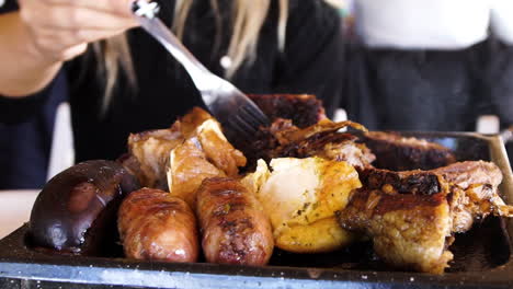 Typical-barbecue-with-meat,-sausage,-and-blood-sausage-in-Argentina,-close-up