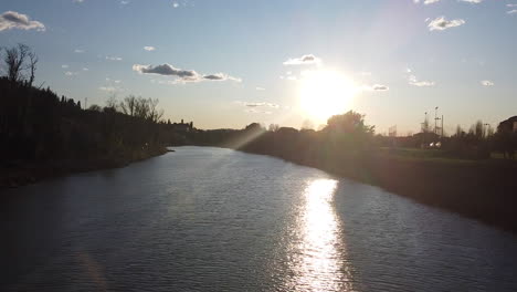 panning sunset drone flies above the arno river. girone small town near fiesole florence, in the tuscany region of italy. december 2019