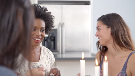 young women in conversation at a dinner table, slow motion