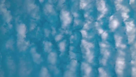 a great time lapse from below, surfing white clouds, blue sky, daylight sun, 4k static video