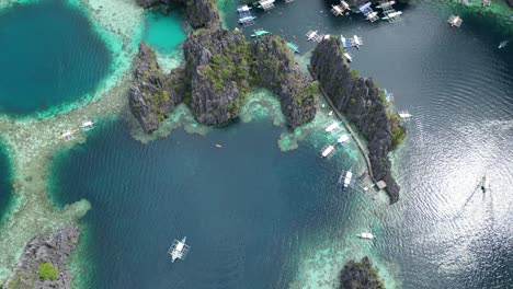 scenic seascape of coron twin lagoon on sunny day, drone bird’s eye