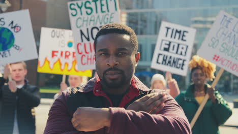 portrait of protestors with placards chanting slogans on demonstration march against climate change