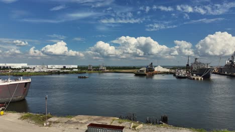 ships docked at a shipyard under a partly cloudy sky