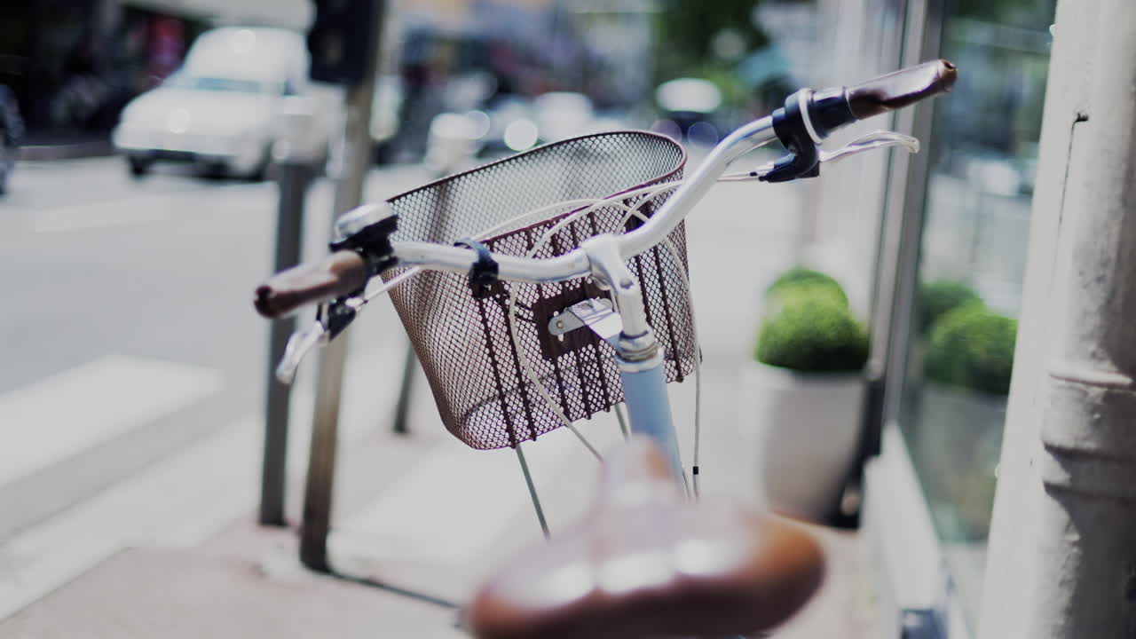 Close up of a blue bicycle with a brown seat on the street