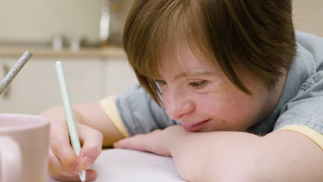 closeup of girl writing on notebook