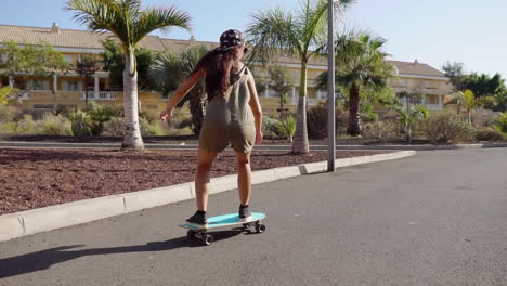 in slow motion, a girl's longboard journey by the beach and palm trees unfolds, showcasing both beauty and skill