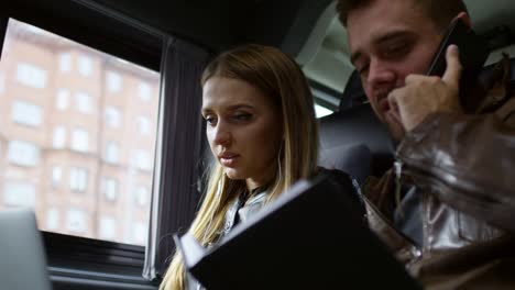 couple using digital devices in car