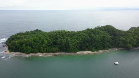 tropical green island in panama, central america, with catamaratan sailboat