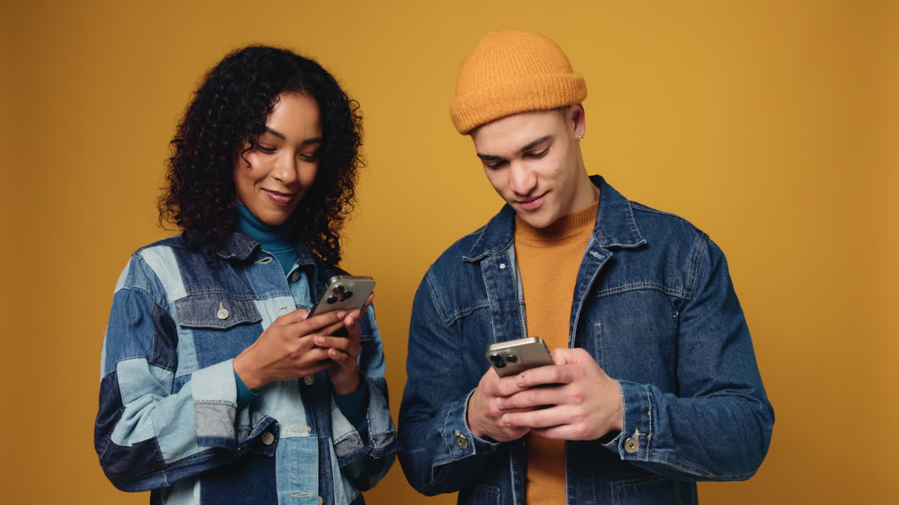 Two people looking at their smartphones