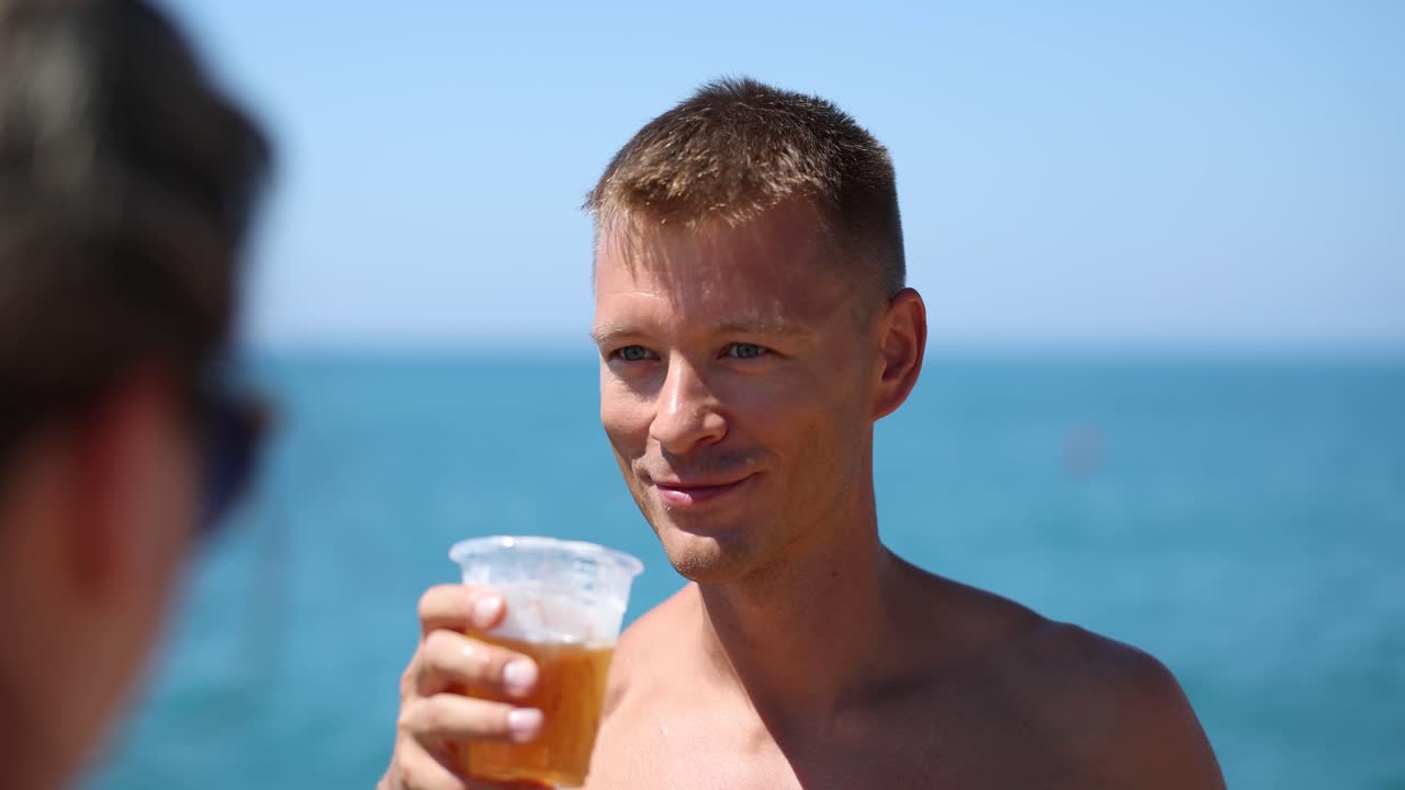 Man drinking beer at the beach