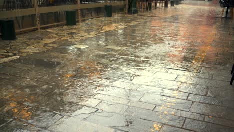 raindrops falling on cobblestone pedestrian pavement 4k, tilt up footage