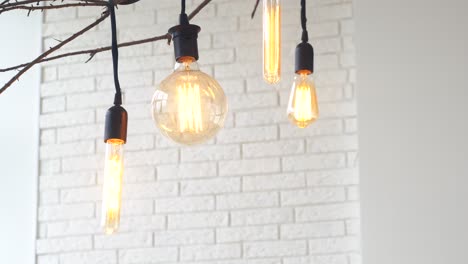 hand adjusting vintage edison bulbs chandelier