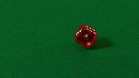 red dice spinning on casino table