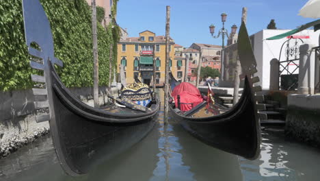 a slowmotion of two gondolas swaying on water on a bright day