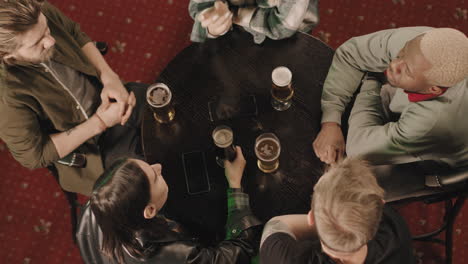 company of friends playing game at table