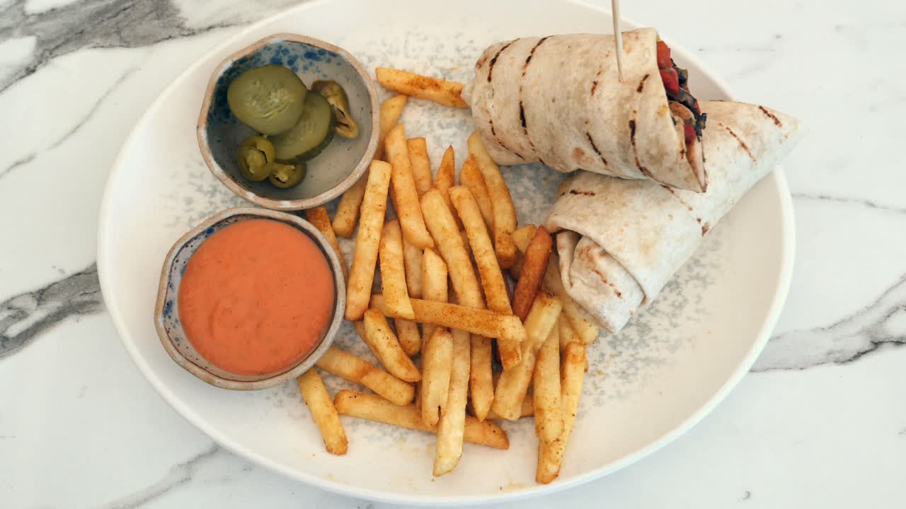 Delicious Wrap Meal with Fries and Sauce