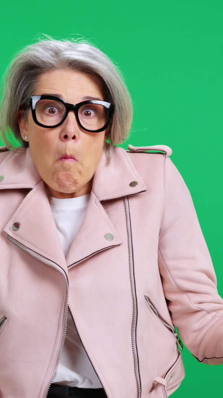 Mature Woman with Glasses Showing Confusion and Surprise on Green Screen