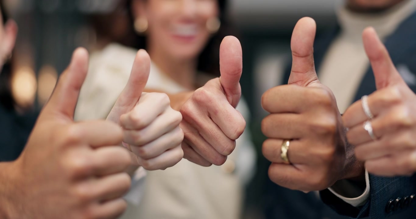 Diverse Business Team Giving Thumbs Up in Office