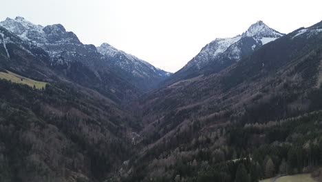 Aerial-View-of-Mountain-Landscape-with-Snow-covered-Mountains-and-Forest-in-winter,-Austria,-4K-30-fps-video