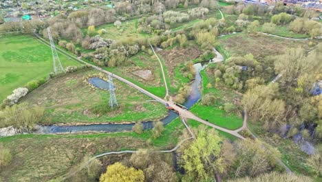 Water-is-running-in-the-natural-stream-and-electrical-current-is-running-through-the-wires-on-the-outskirts-of-Leicester,-UK