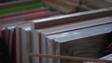 indonesian laminated books neatly arranged on a bookshelf