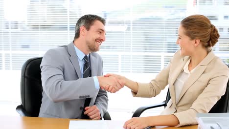 business team looking at document and giving thumbs up to camera