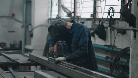 a working welder connects metal parts by gas or electric welding in slow motion