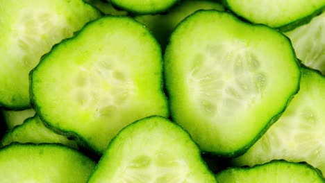 trozos cortados de pepino verde apilados en una colina giran. trozos de pepino cortados frescos están girando