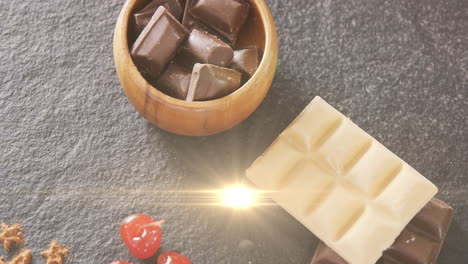 animation of light over milk and white chocolate in bowl lying on grey surface