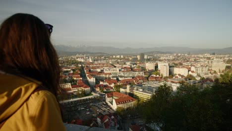 tourists observing ljubljana city in slovenia from panoramic point of view