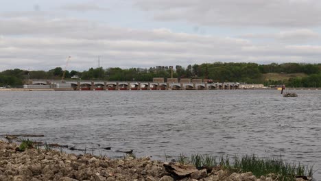 view of lock and dam 14 on the mississippi river on a cloudy spring day, near leclair iowa - looping