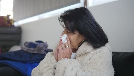 An-older-woman-is-sick-and-blows-her-runny-nose