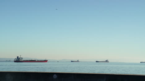 military boats in bay with clear skies and