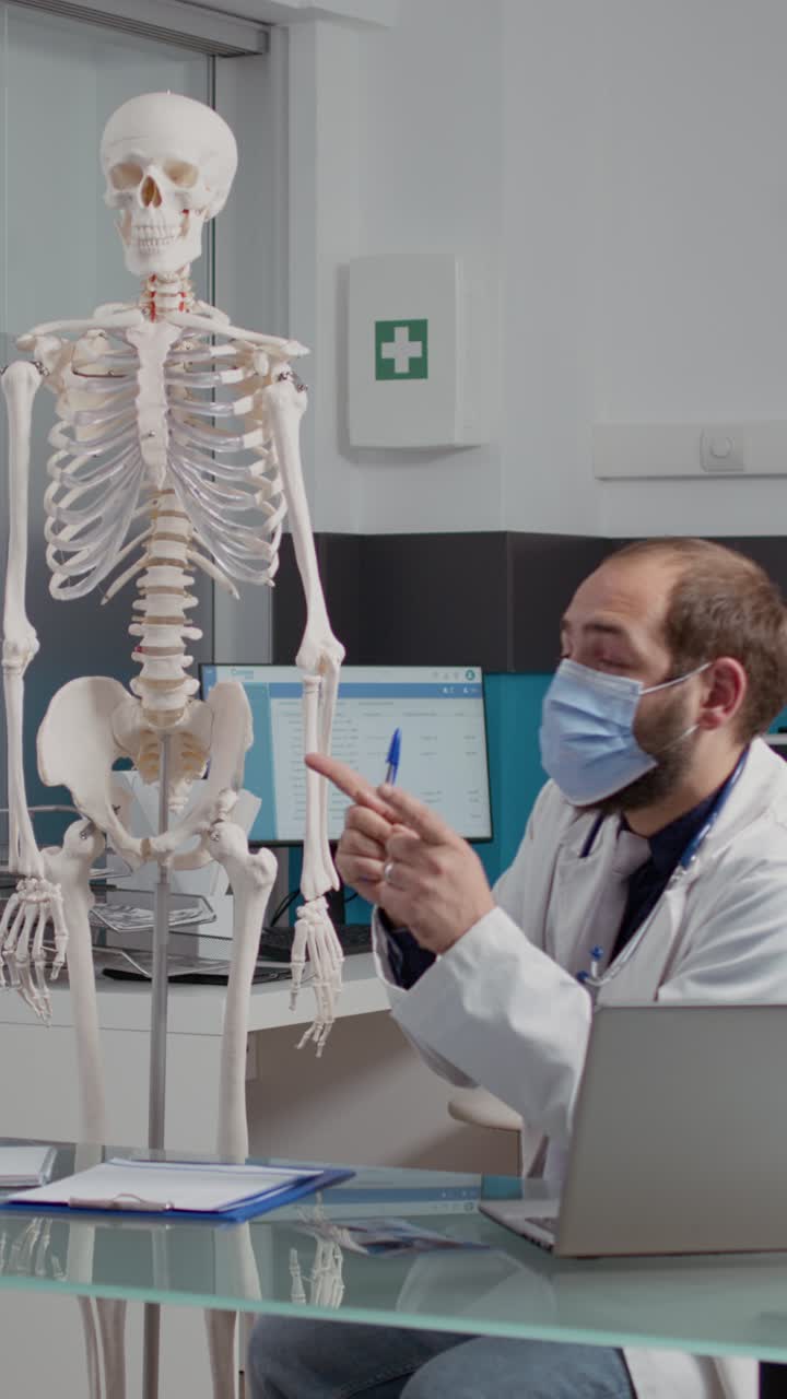 Doctor explaining anatomy with a skeleton model