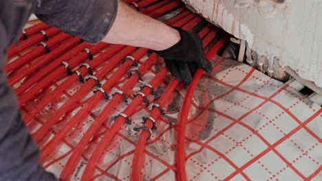 installing underfloor heating pipes for water heating. heating systems. pipes for a heat-insulated floor.