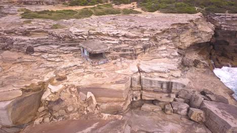 beautiful aerial view of cliff and a little rock house and resting place next to the pacific ocean