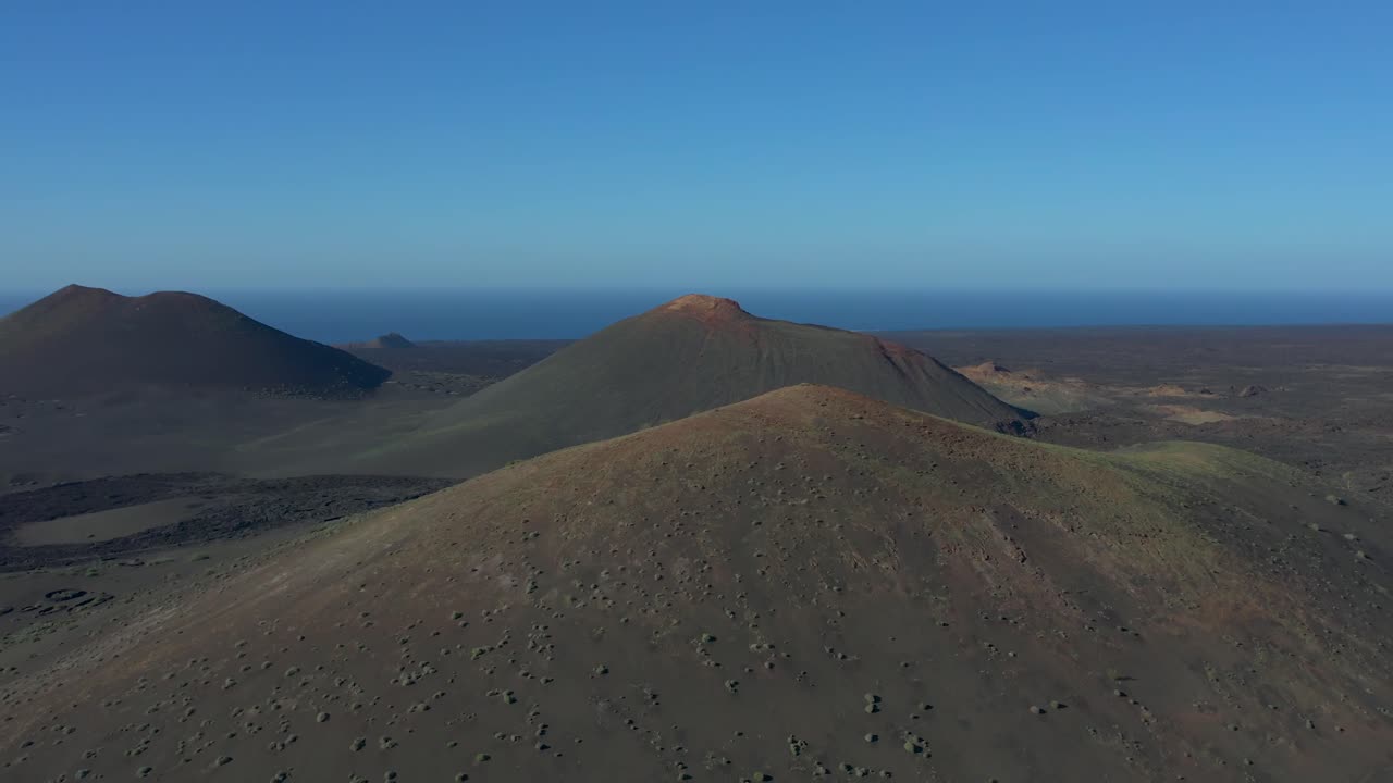 Aerial drone view of mountain sea and volcanoes in Lanzarote, Canary Islands, Spain