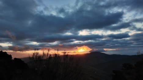 vibrant and dramatic clouds passing over into sunset time lapse