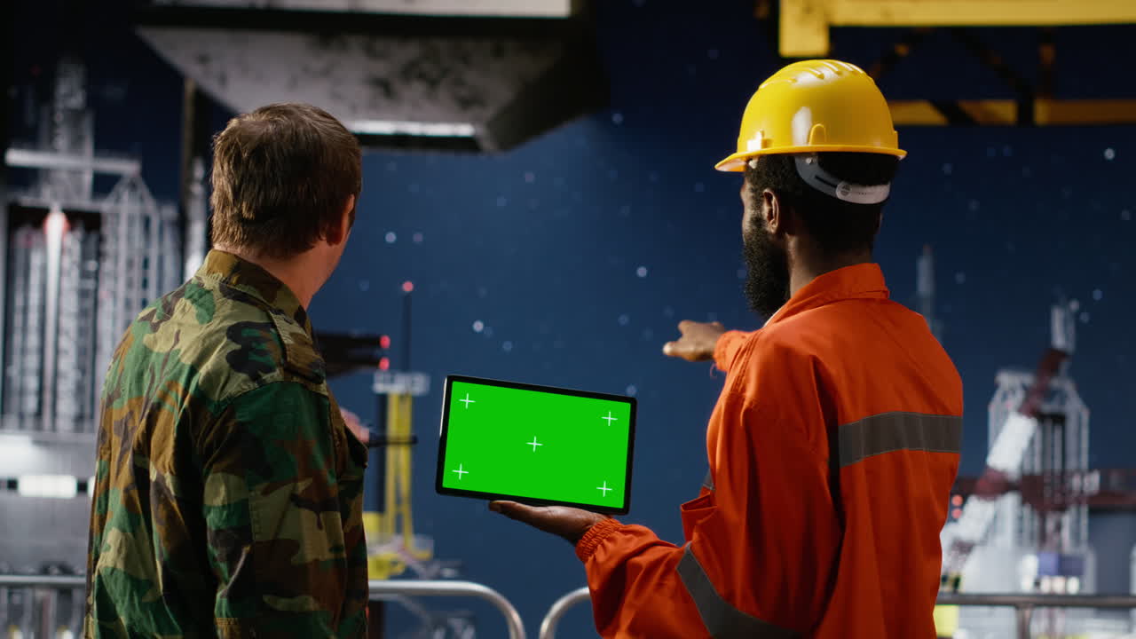Green screen device with naval officer and engineer on oil rig vessel
