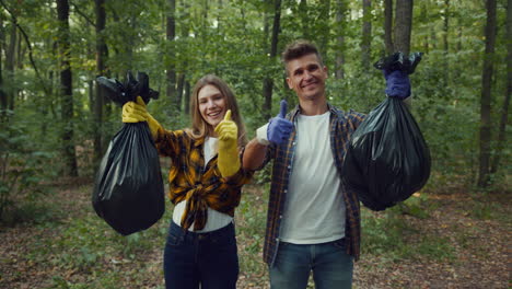 couple volunteering to clean up a forest