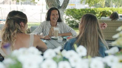 women friends enjoying coffee at an outdoor cafe