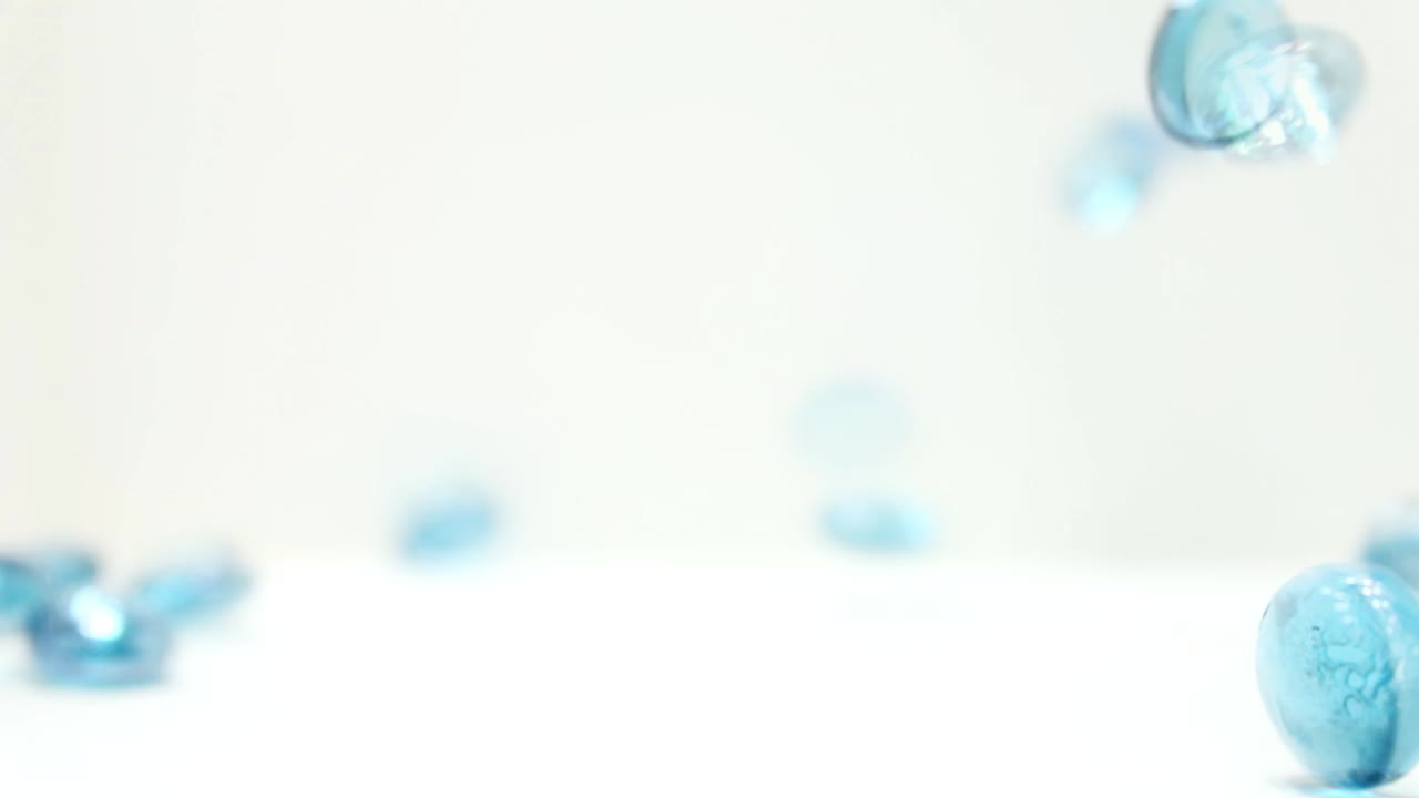 Forward Slow Motion of Marbles and Disks bouncing and tumbling into frame