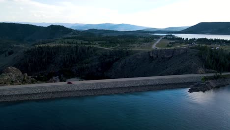 aerial view of a scenic lake and dam in the mountains