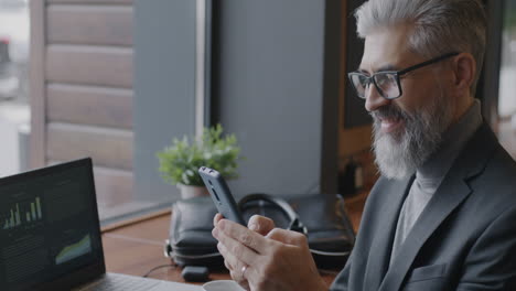 businessman using smartphone in a cafe